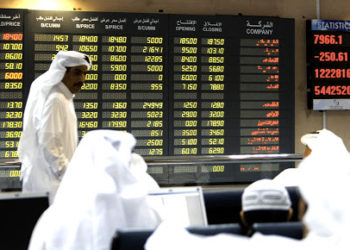 Investors follow the stock market activity on a monitor at the Doha Securities Market in Doha on September 16, 2008. Global equities tumbled for a second day running today as anxious investors waited to see if US insurance giant American International Group (AIG) would suffer the same fate as bankrupt US investment bank Lehman Brothers. AFP PHOTO/KARIM JAAFAR (Photo credit should read KARIM JAAFAR/AFP/Getty Images)