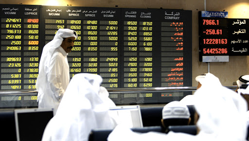 Investors follow the stock market activity on a monitor at the Doha Securities Market in Doha on September 16, 2008. Global equities tumbled for a second day running today as anxious investors waited to see if US insurance giant American International Group (AIG) would suffer the same fate as bankrupt US investment bank Lehman Brothers. AFP PHOTO/KARIM JAAFAR (Photo credit should read KARIM JAAFAR/AFP/Getty Images)